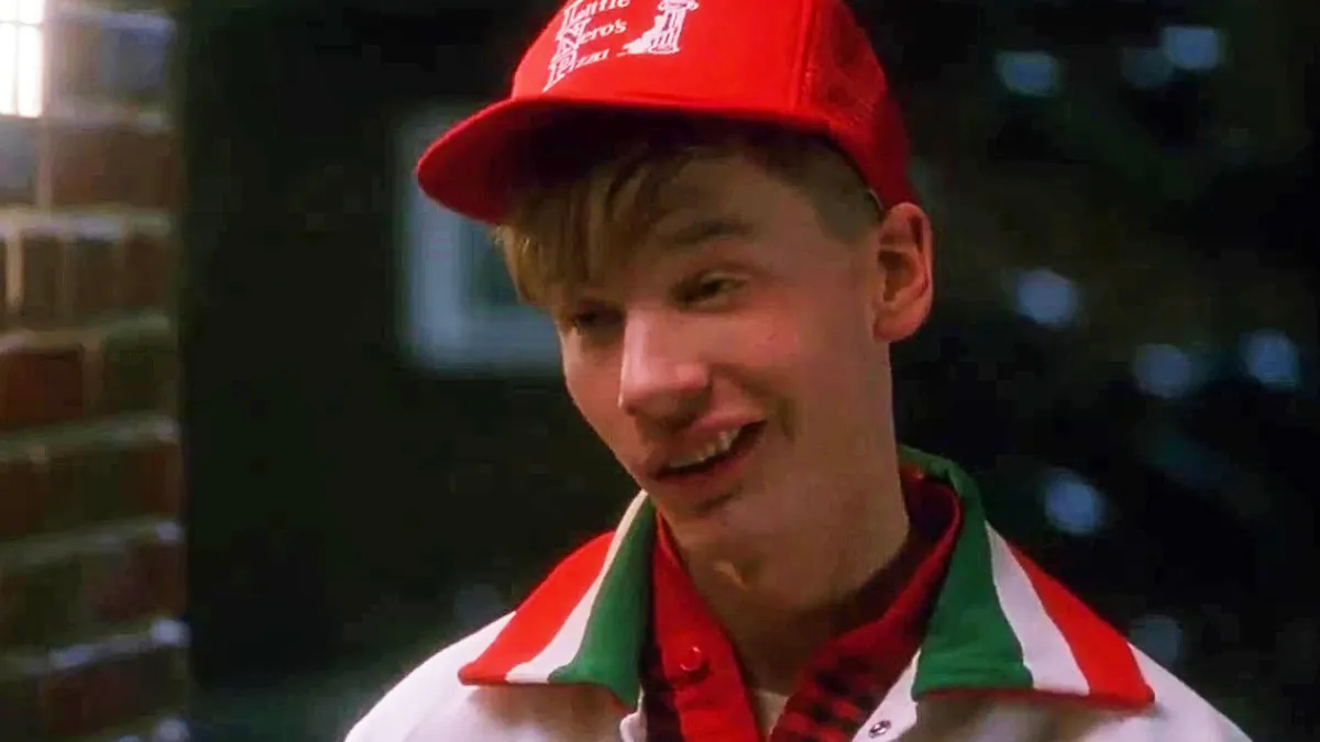 A young man in a Little Nero's Pizza uniform.