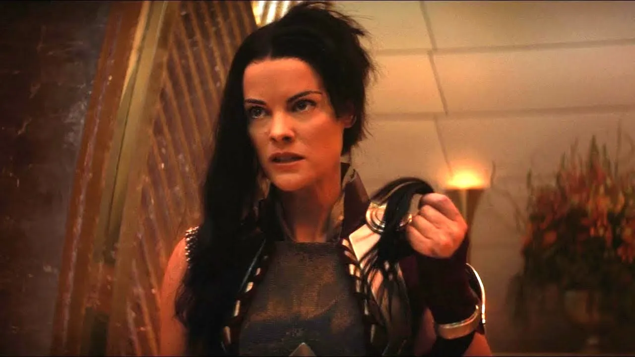 Lady Sif (Jaimie Alexander) looks furious with a shorn left side of her head as she holds the cut hair in her hand. 