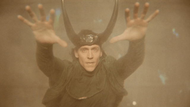 Tom Hiddleston's Loki dons his horned helmet as he controls time in the Loki season 2 finale.