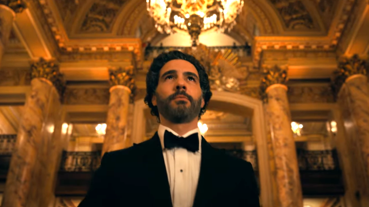 Tarah Rahim's Ezekiel Sims walks through a classy ballroom while dressed in a tuxedo in the 'Madame Web' trailer.