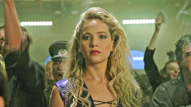 Jennifer Lawrence as Raven/Mystique in her human form in the crowd of a cage match in a still from X-Men: Apocalypse