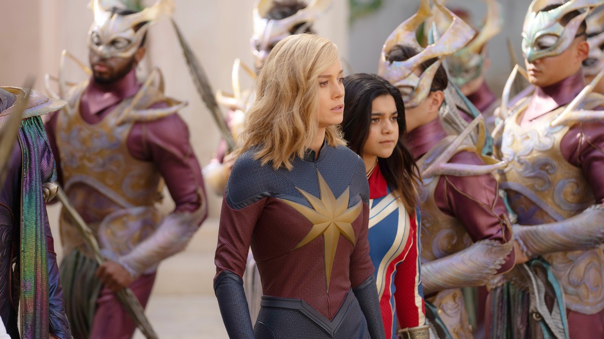 Carol Danvers and Kamala Khan surrounded by Aladnan guards on the planet Aladna in The Marvels. 