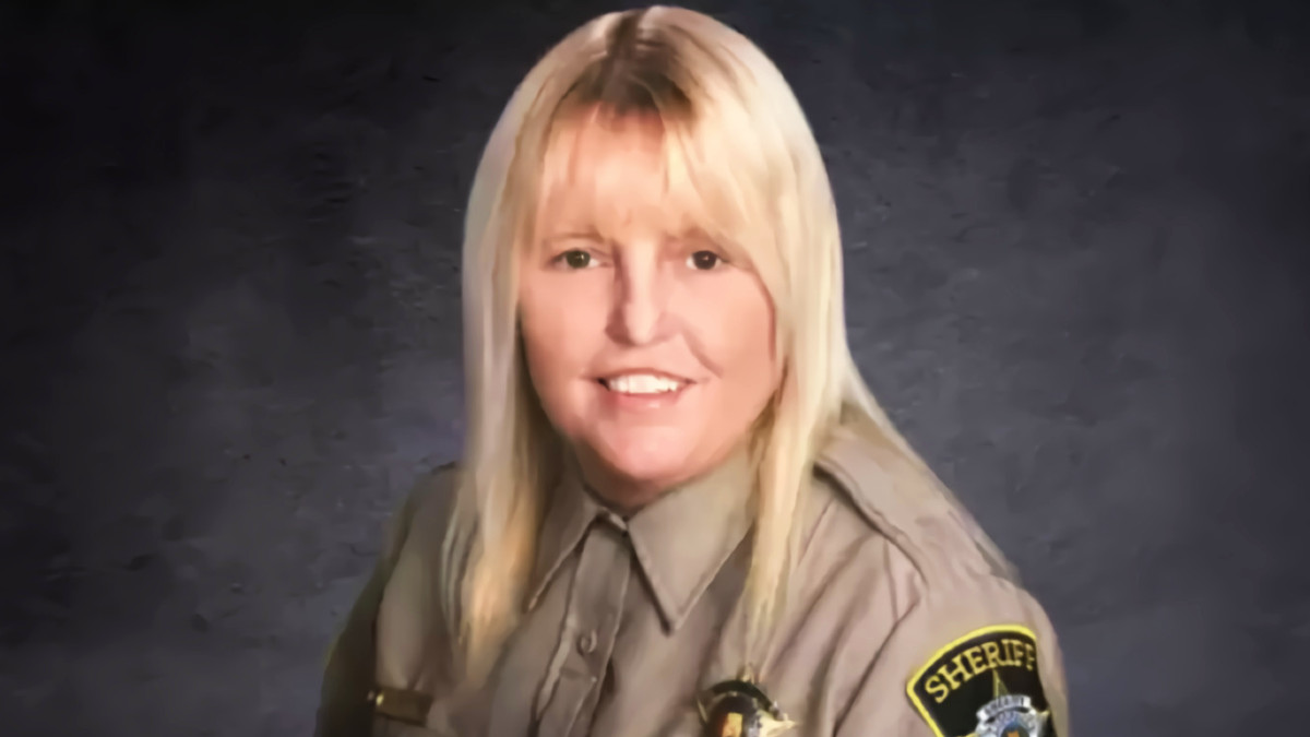 A blonde woman in a tan officer's uniform.