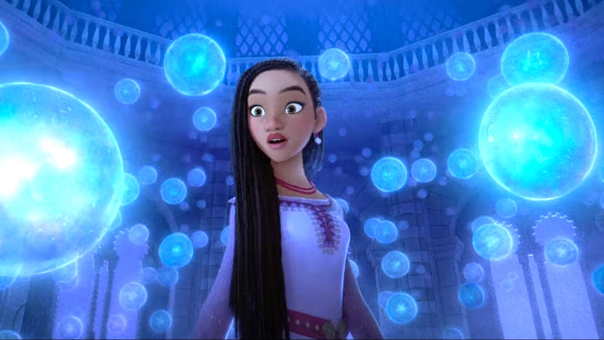 Asha surrounded by glowing blue orbs in Disney's Wish.