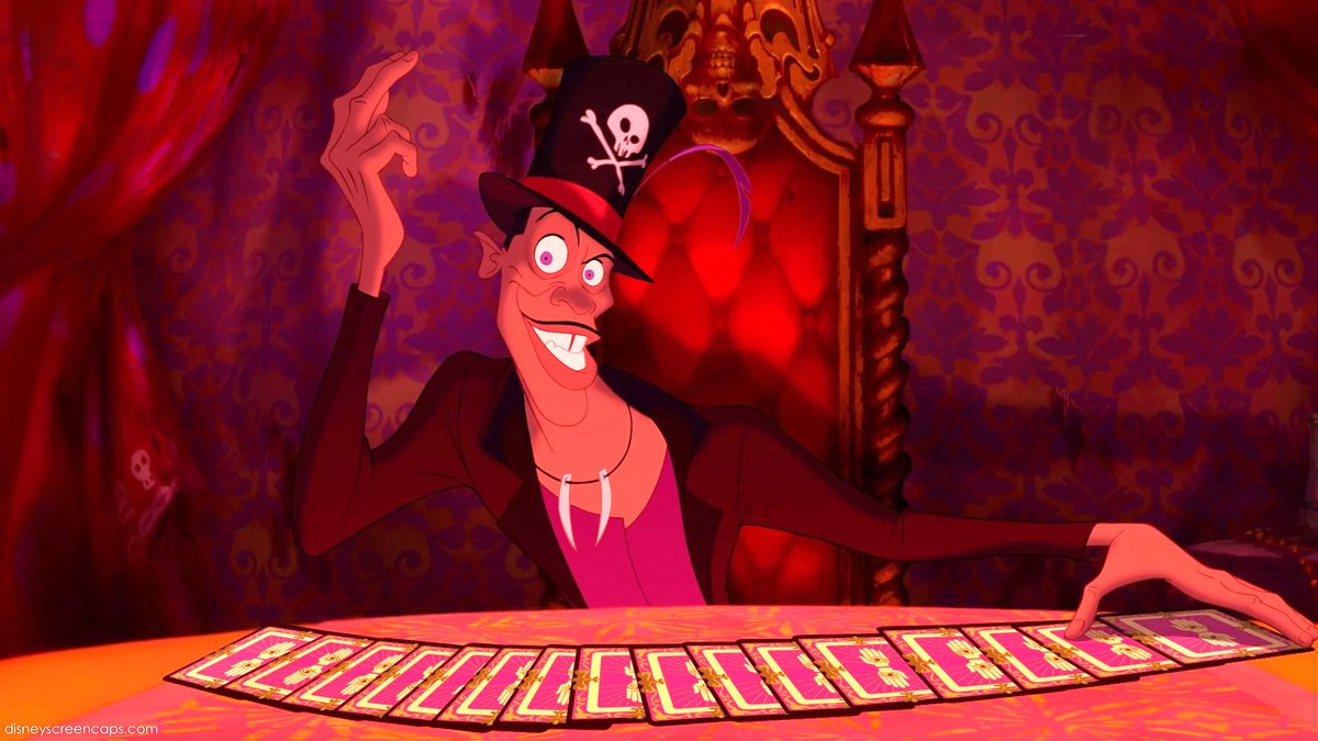 Dr. Facilier grins in his voodoo parlor as he fans out a pack of cards in The Princess and The Frog