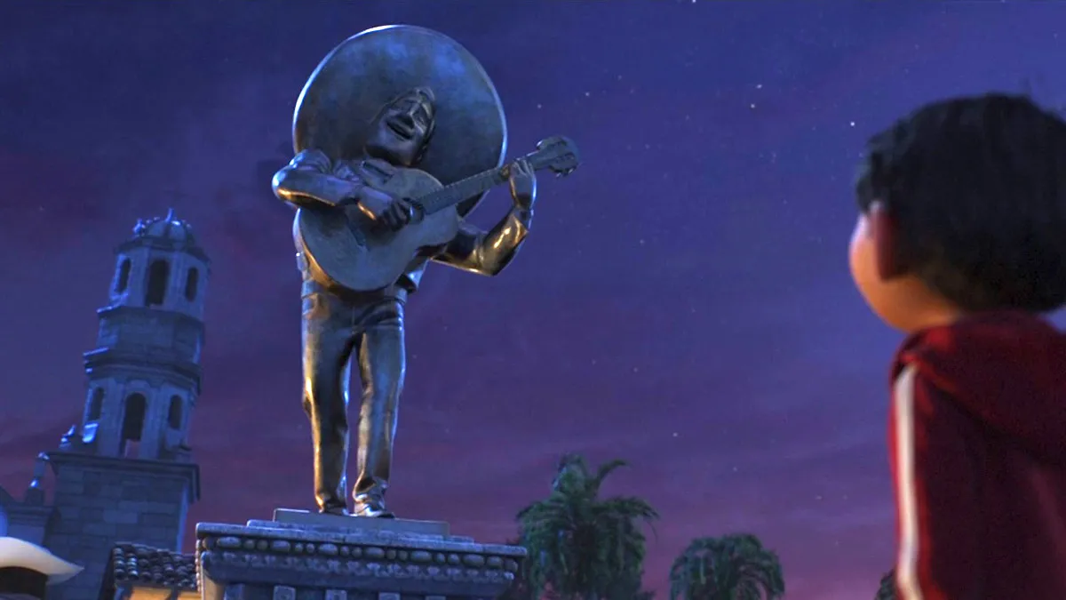 What Message Is Written on Ernesto de la Cruz s Statue in Coco