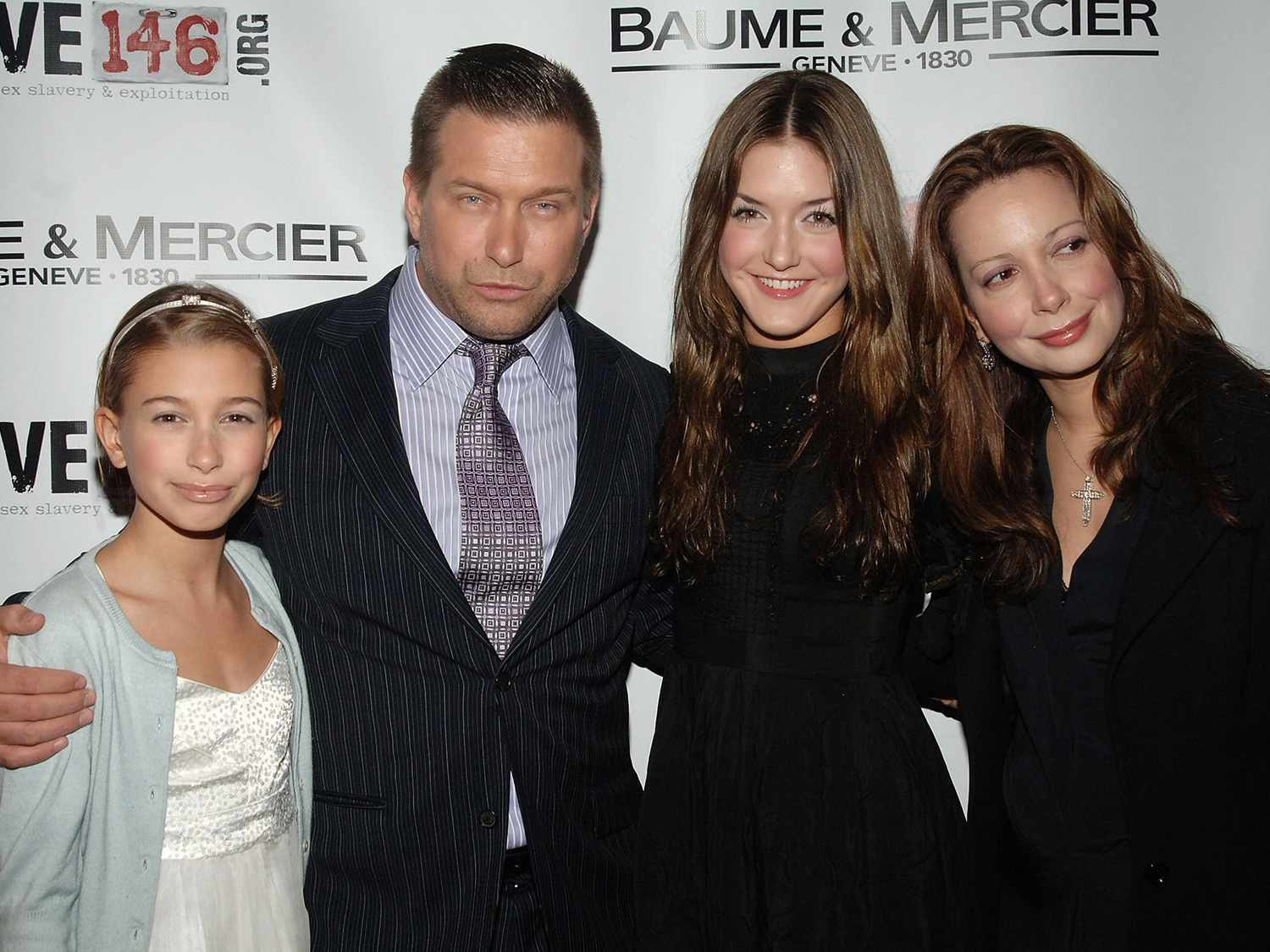 The Baldwin family is posing for a picture on the red carpet. 