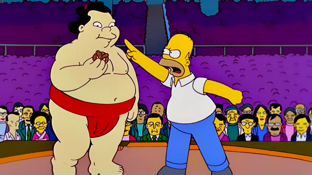 Homer Simpson is pointing his finger at a sumo wrestler. 
