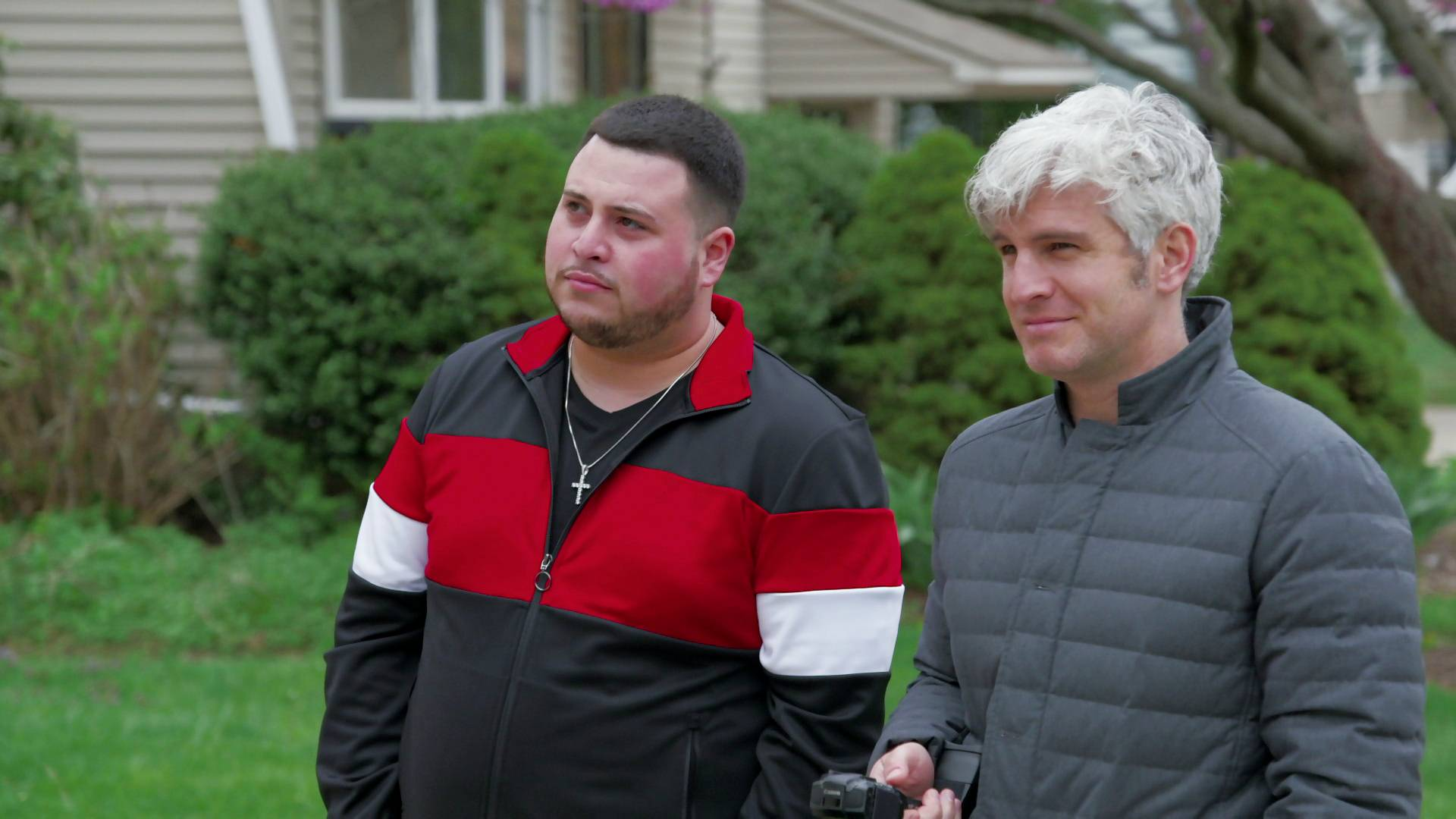 Max is holding a camera and standing next to a man on Catfish.