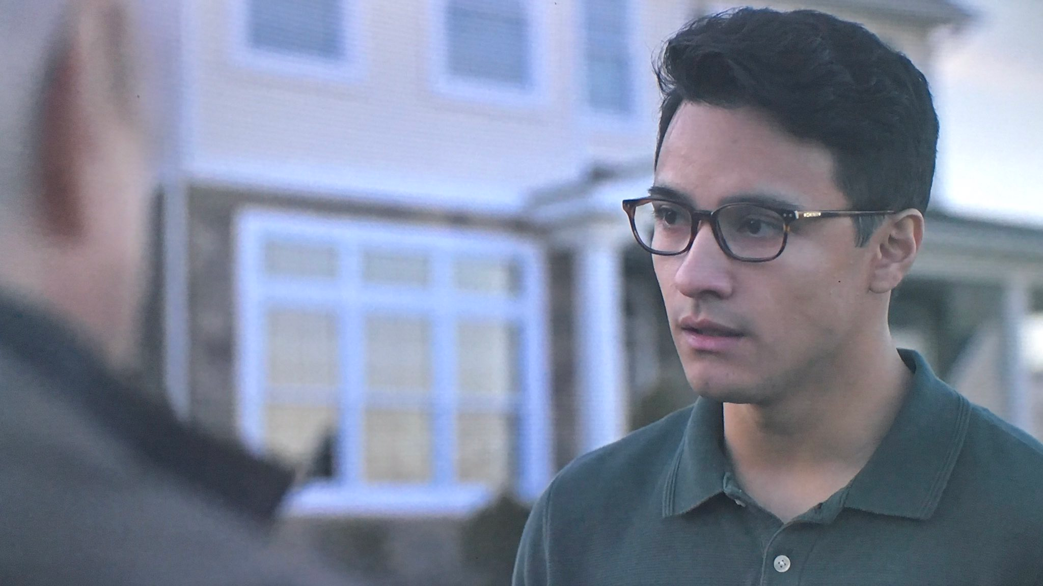 Brandon Perea is wearing glasses and looking at something off camera in The OA. 