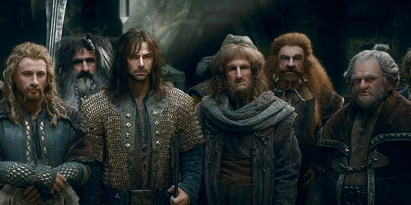 The dwarfs from Lord of the Rings are standing together. 