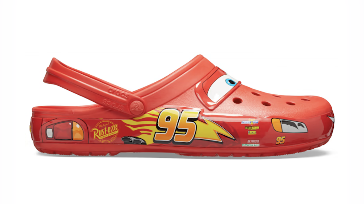 A profile view of the red and yellow Lightning McQueen Crocs