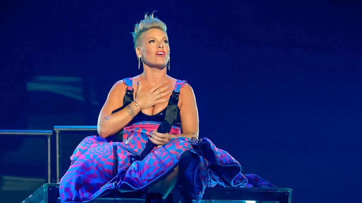 Pink sitting on stage at the 2023 iHeartRadio Music Awards