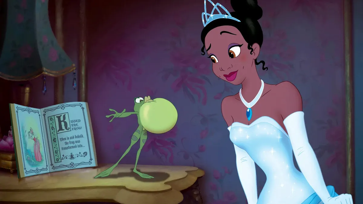 Tiana raises an eyebrow as frog Naveem inflates his throat while standing on a dresser in The Princess and the Frog