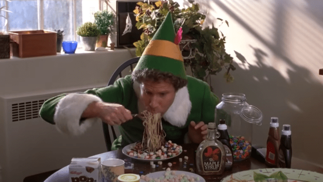 Buddy the Elf eating spaghetti covered in candy.