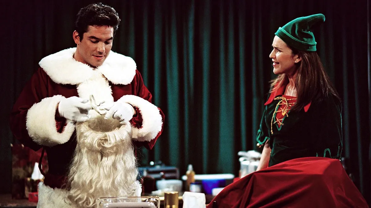 Roz, dressed as an elf, chats with Dean Cain's store Santa Claus in Frasier: We Two Kings