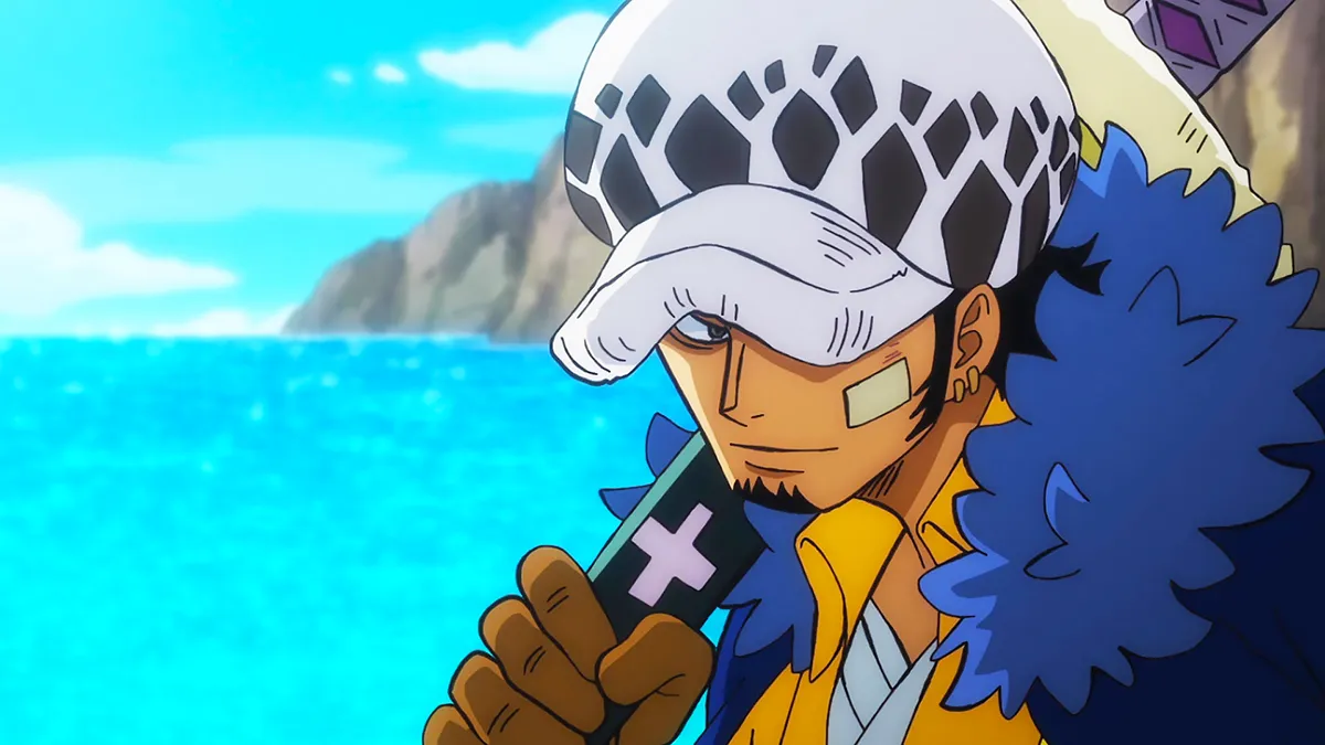 Trafalgar Law smiling with the sea behind him in One Piece