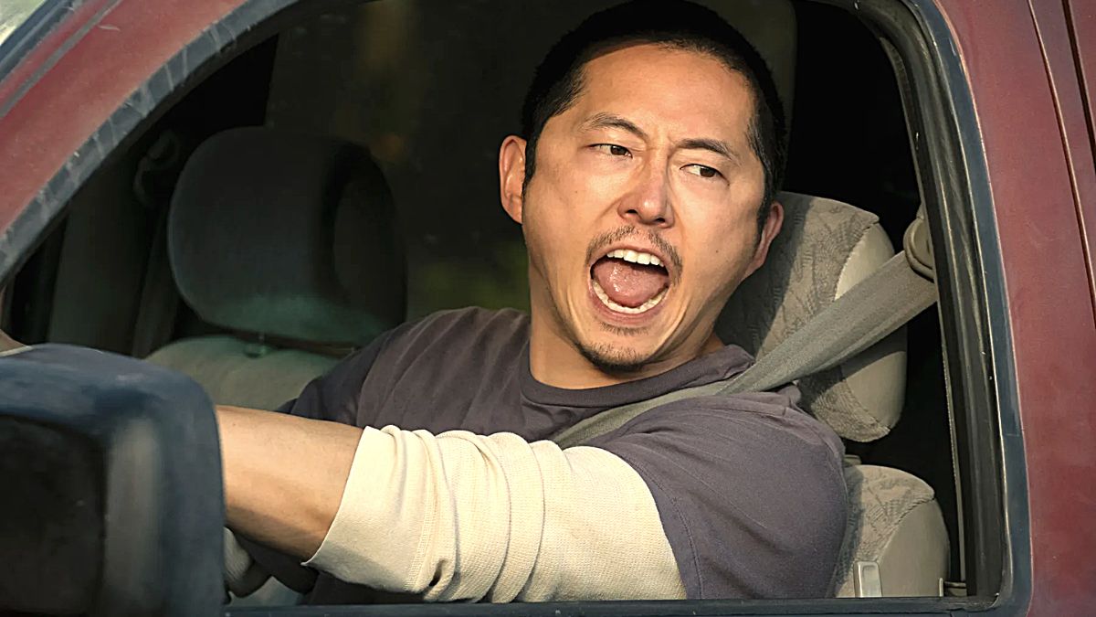Steven Yeun looks angry as he shouts from the driving seat of his car in the Netflix show 'Beef'.