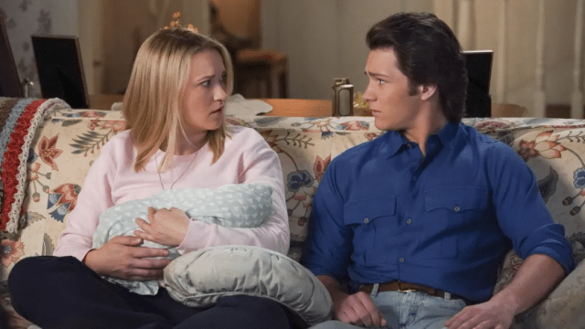 Georgie and Mandy looking concerned and holding a baby on 'Young Sheldon.'