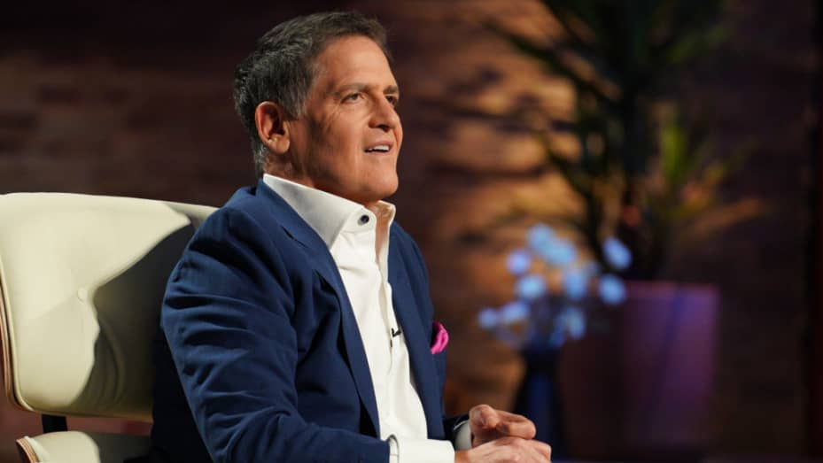 Mark Cuban is listening to and watching a pitch on Shark Tank.