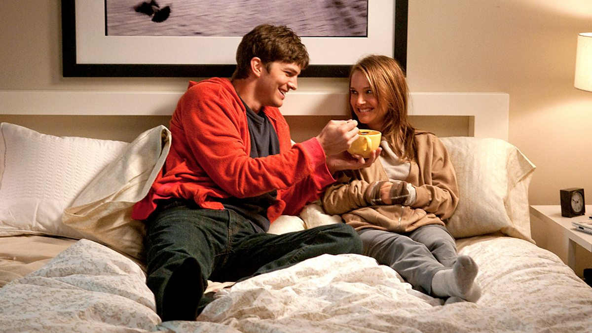 Emma and Adam are drinking tea in bed in No Strings Attached.