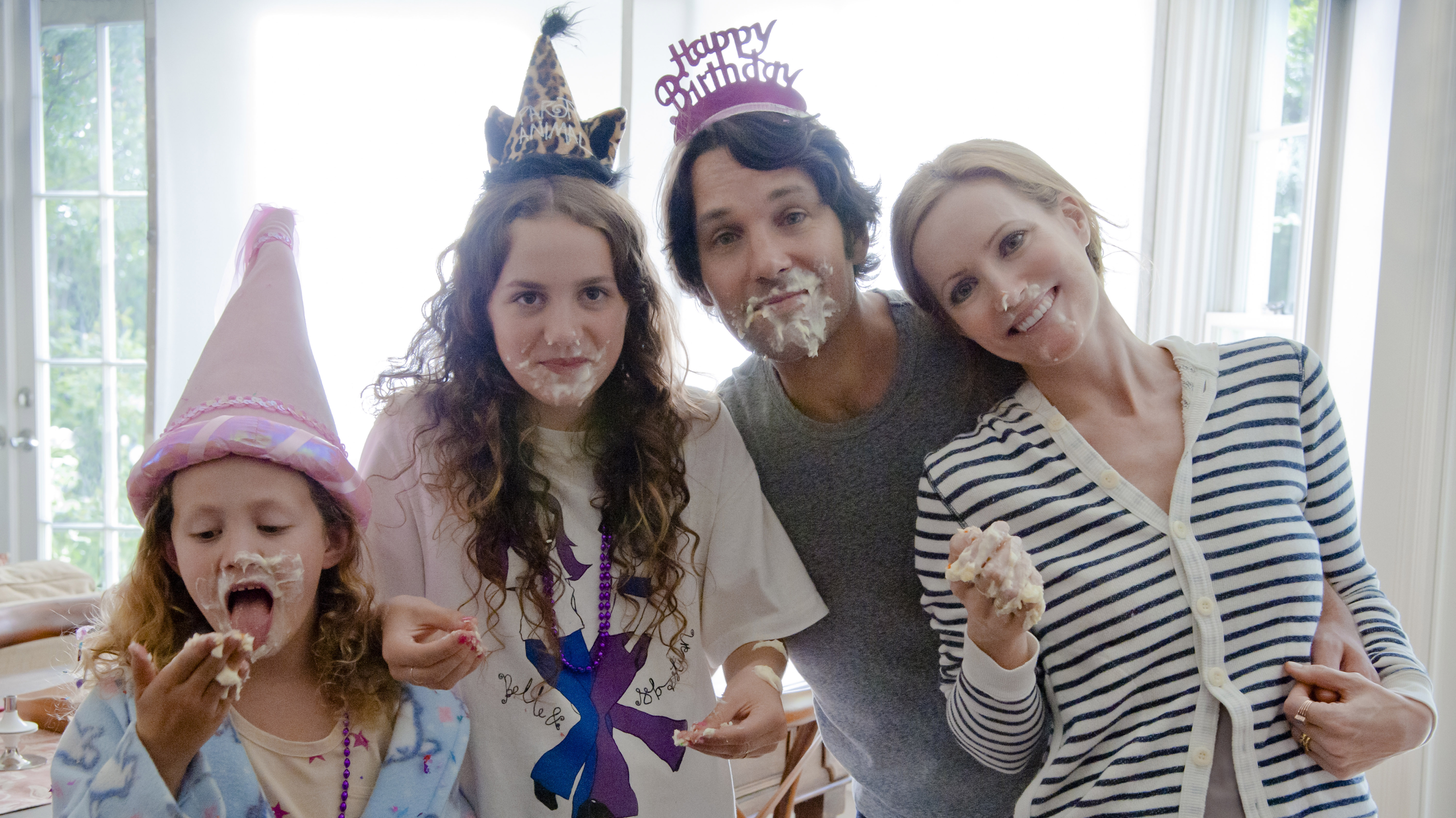 The cast of This is 40 is posing for a picture with cake on their faces.
