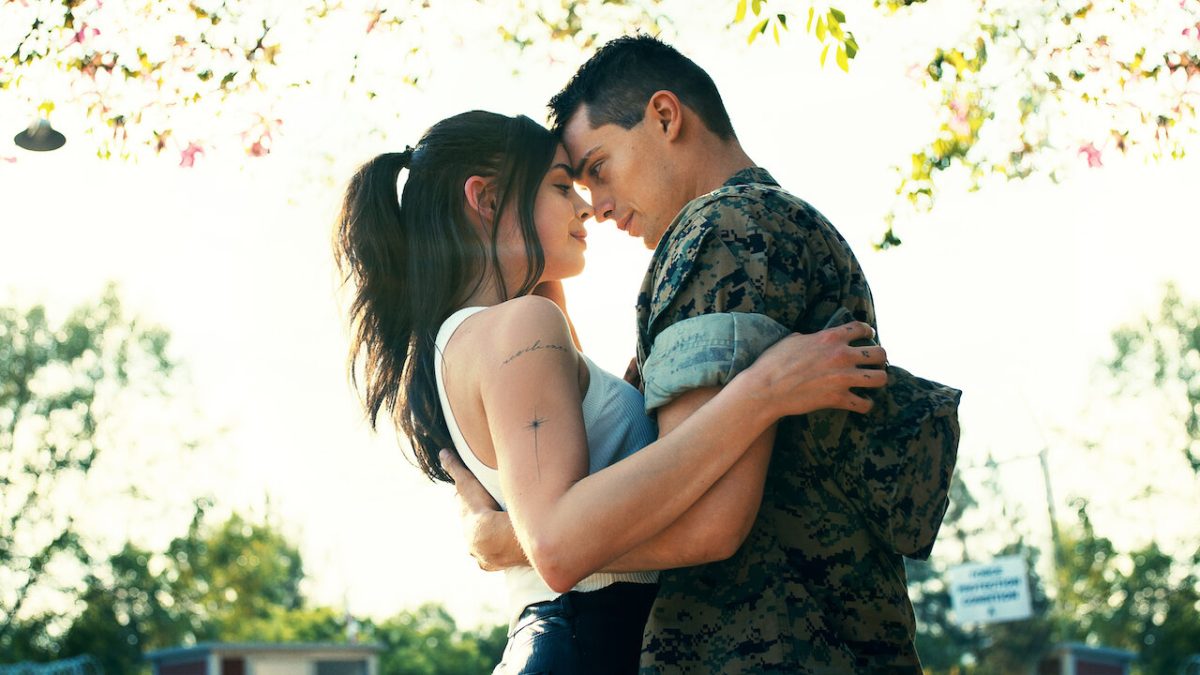 Cassie (Sofia Carson) and Luke (Nicholas Galitzine) in a romantic embrace in a promo image for Purple Hearts.