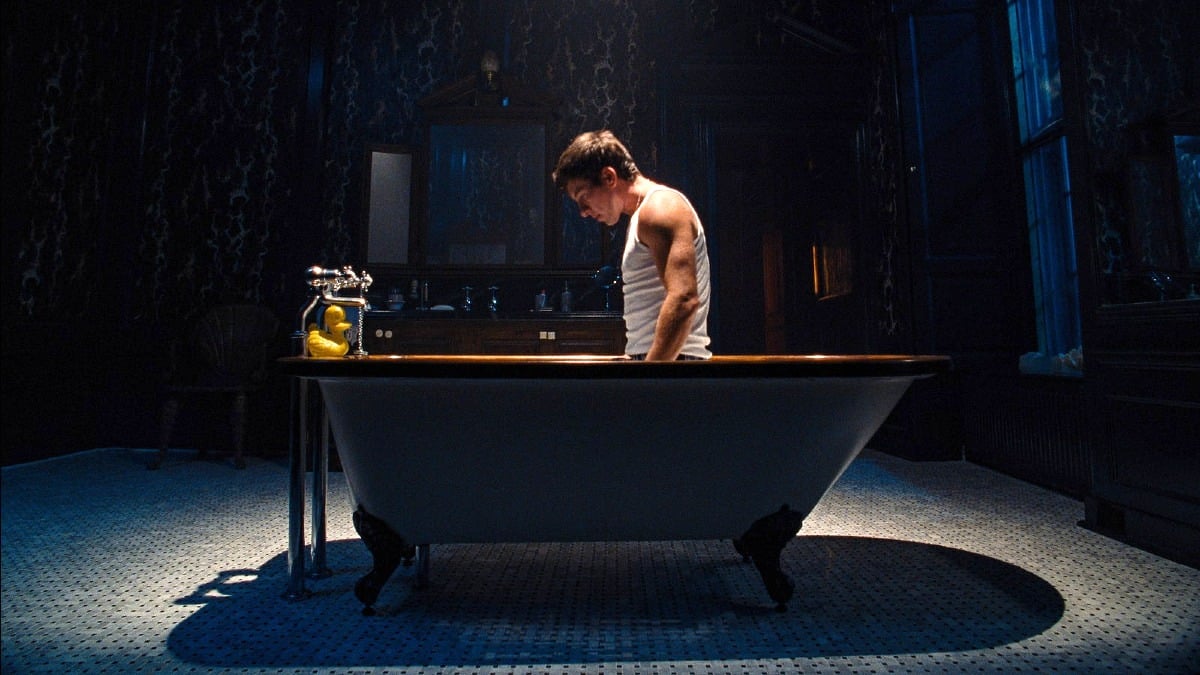 Barry Keoghan as Oliver Quick kneeling inside a bathtub in 'Saltburn'.