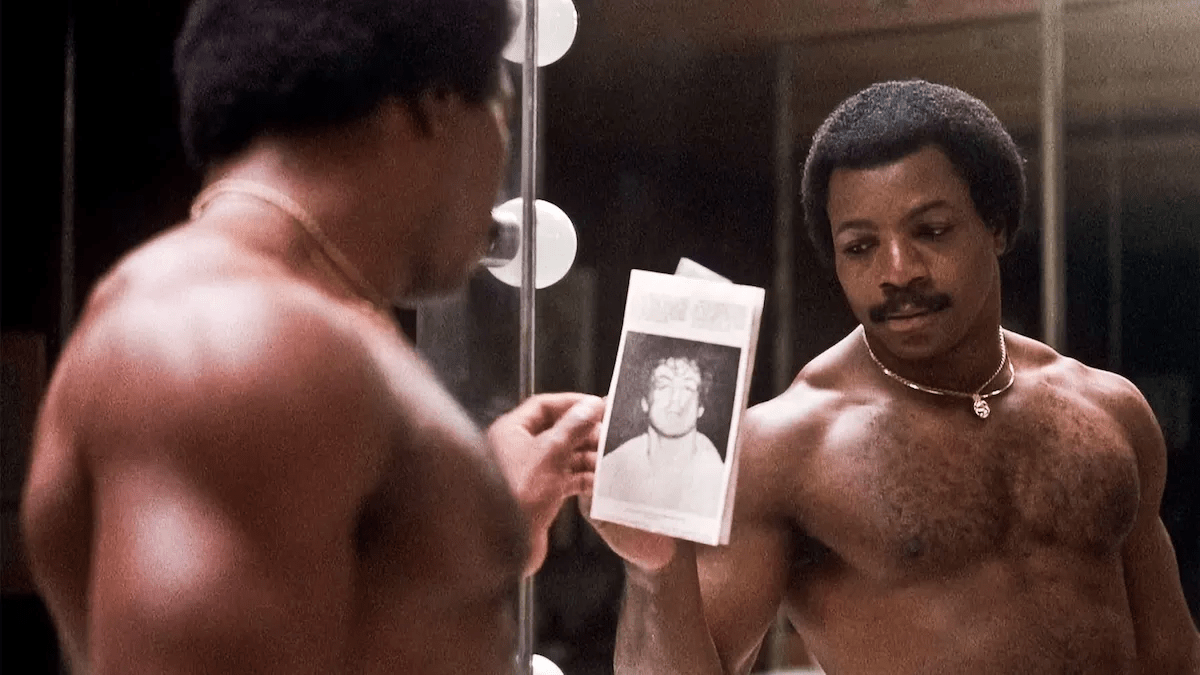 Carl Weathers as Apollo Creed, standing in front of a mirror.