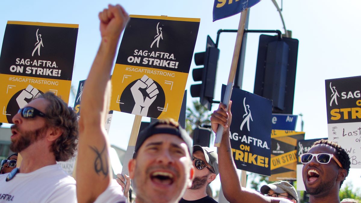 SAG-AFTRA members and supporters chant outside Paramount Studios on day 118 of their strike against the Hollywood studios on November 8, 2023 in Los Angeles, California. A tentative labor agreement has been reached between the actors union and the Alliance of Motion Picture and Television Producers (AMPTP) with the strike set to end after midnight. (Photo by Mario Tama/Getty Images)