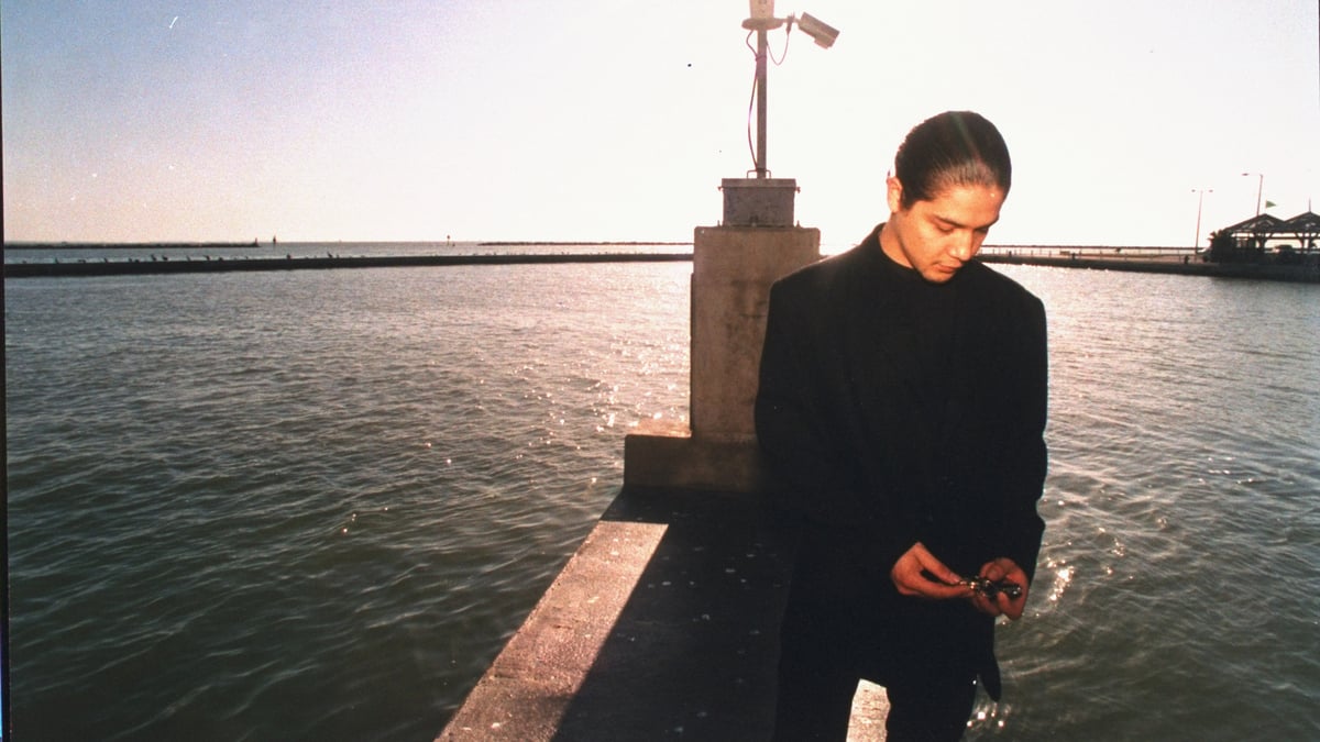 Chris Perez, husband of late tejano singer Selena who was shot by her former fan club pres. Yolanda Saldivar, standing on dock nr. water.    