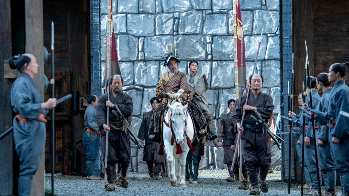 Lord Toranaga (Hiroyuki Sanada) and his men ride through a gate on horseback in Shogun