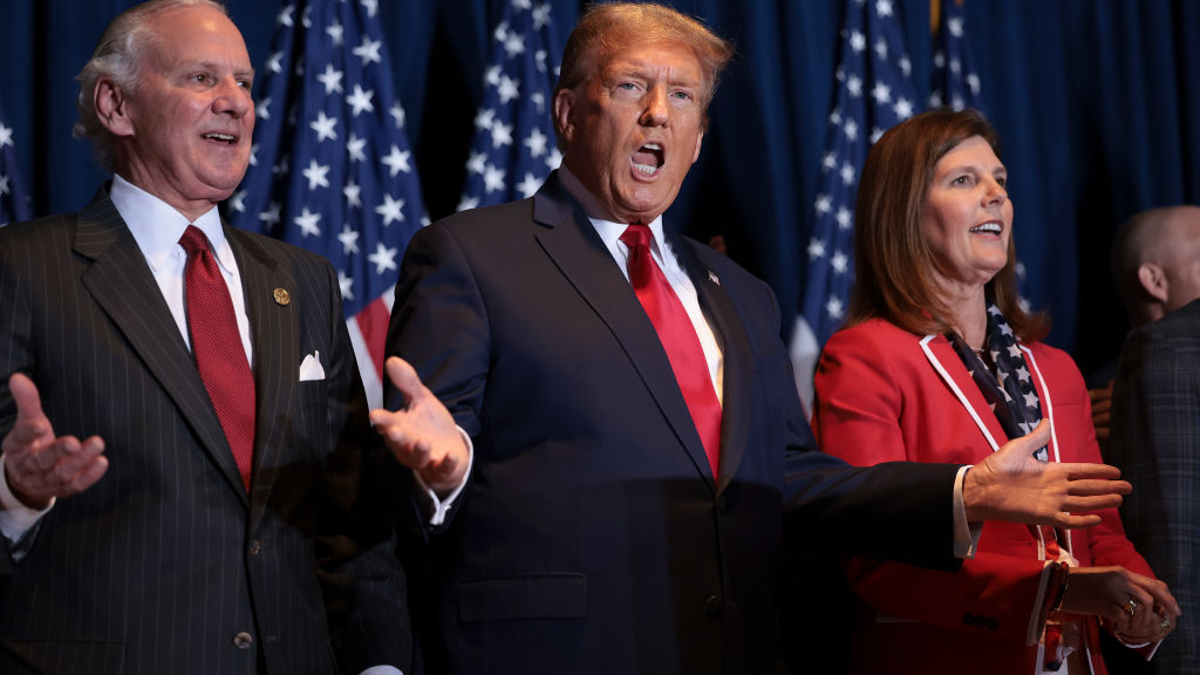 Republican presidential candidate and former President Donald Trump gestures to supporters at an election night watch party at the State Fairgrounds on February 24, 2024 in Columbia, South Carolina. Trump defeated Republican presidential candidate former U.N. Ambassador Nikki Haley in her home state as South Carolina held its primary today. Also pictured are South Carolina Governor Henry McMaster (L) and South Carolina Lieutenant Governor Pamela Evette (R).