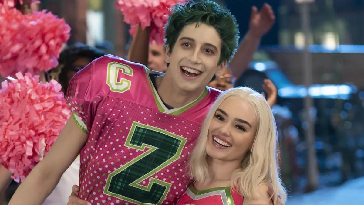 Zed and Addison embrace while wearing pink football and cheerleading uniforms in Zombies 3