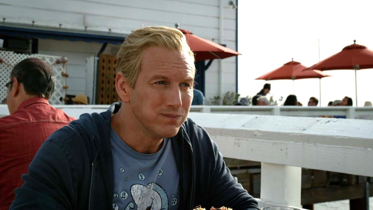Orm (Patrick Wilson) enjoys a cockroach burger in the final scene of Aquaman and the Lost Kingdom 