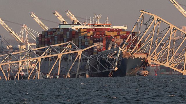 A cargo ship is shown after running into and collapsing the Francis Scott Key Bridge on March 26, 2024 in Baltimore, Maryland. Rescuers are searching for at least seven people, authorities say, while two others have been pulled from the Patapsco River.