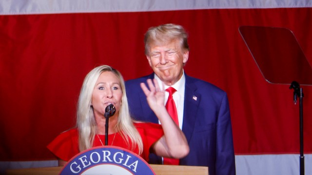 Former U.S. President Donald Trump looks on as Rep. Marjorie Taylor Greene (R-GA) speaks during his remarks at the Georgia state GOP convention at the Columbus Convention and Trade Center on June 10, 2023 in Columbus, Georgia. On Friday, former President Trump was indicted by a federal grand jury on 37 felony counts in Special Counsel Jack Smith’s classified documents probe.