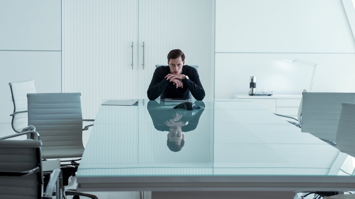 Bill Skarsgard sitting alone in a glass desk in Season 3 of Hemlock Grove