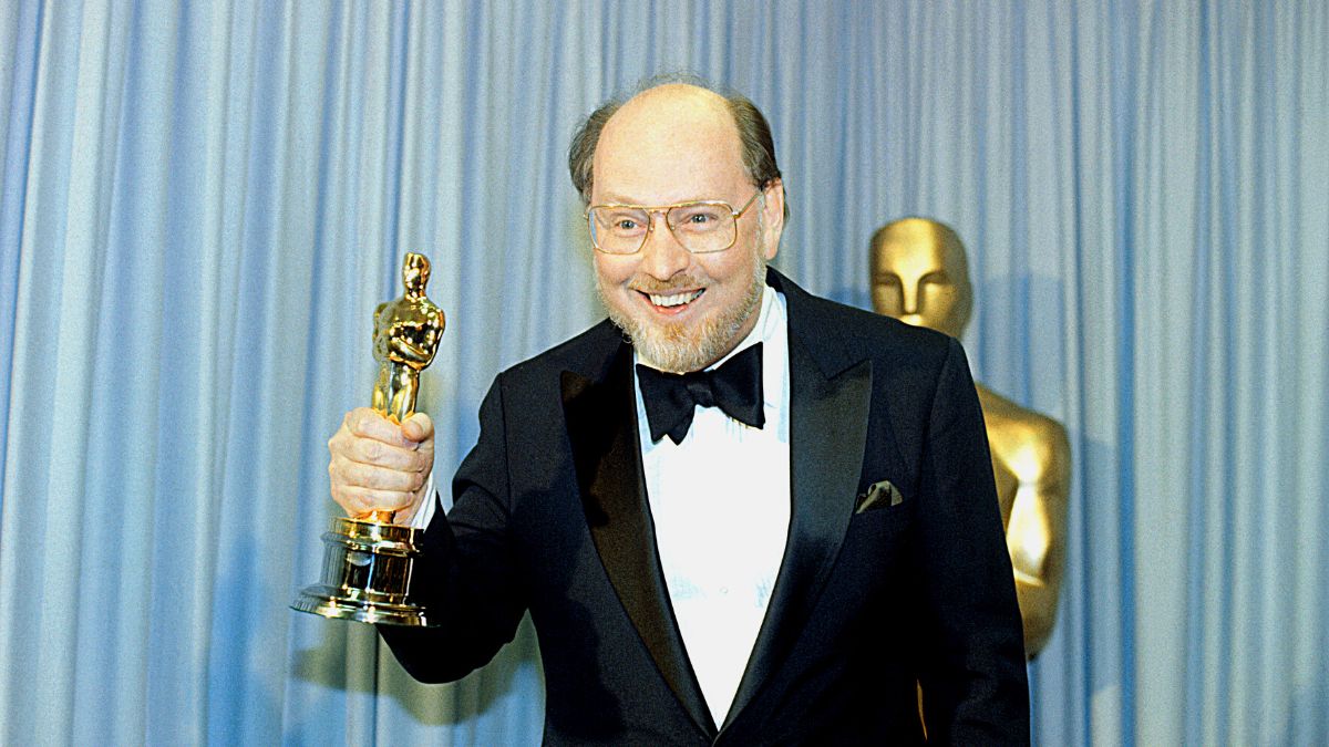 John Williams, the winner of the 1982 Academy Award for the Best Original Score for E.T., stands backstage during the Academy Awards Ceremony holding his Oscar.