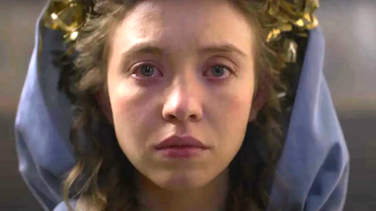 Sydney Sweeney as a nun with a blue veil in the horror movie Immaculate