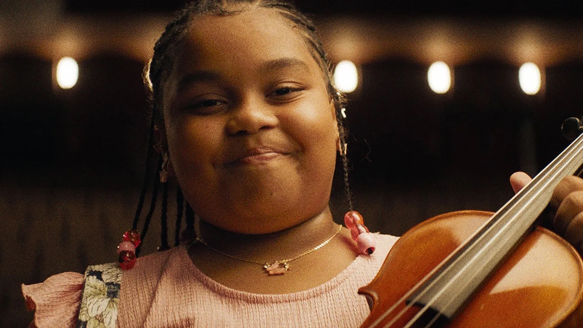 Porché Brinker smiles as she proudly holds her violin.