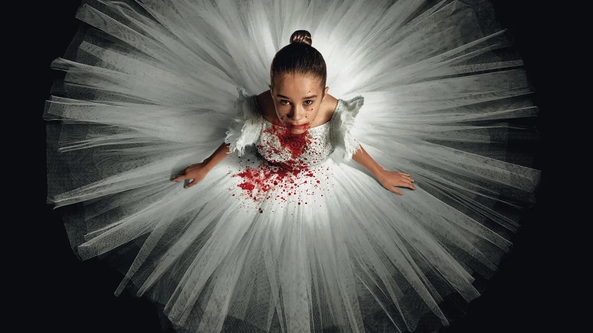 Alisha Weir wearing a blood-stained white ballerina dress in horror movie Abigail