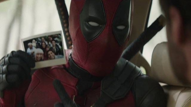 Ryan Reynolds showing Deadpool's family photo in Deadpool & Wolverine