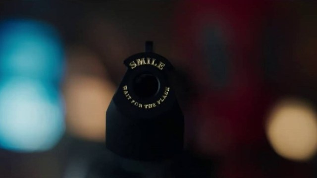 The barrel of a gun with the saying "Smile, wait for the flash" in Deadpool & Wolverine