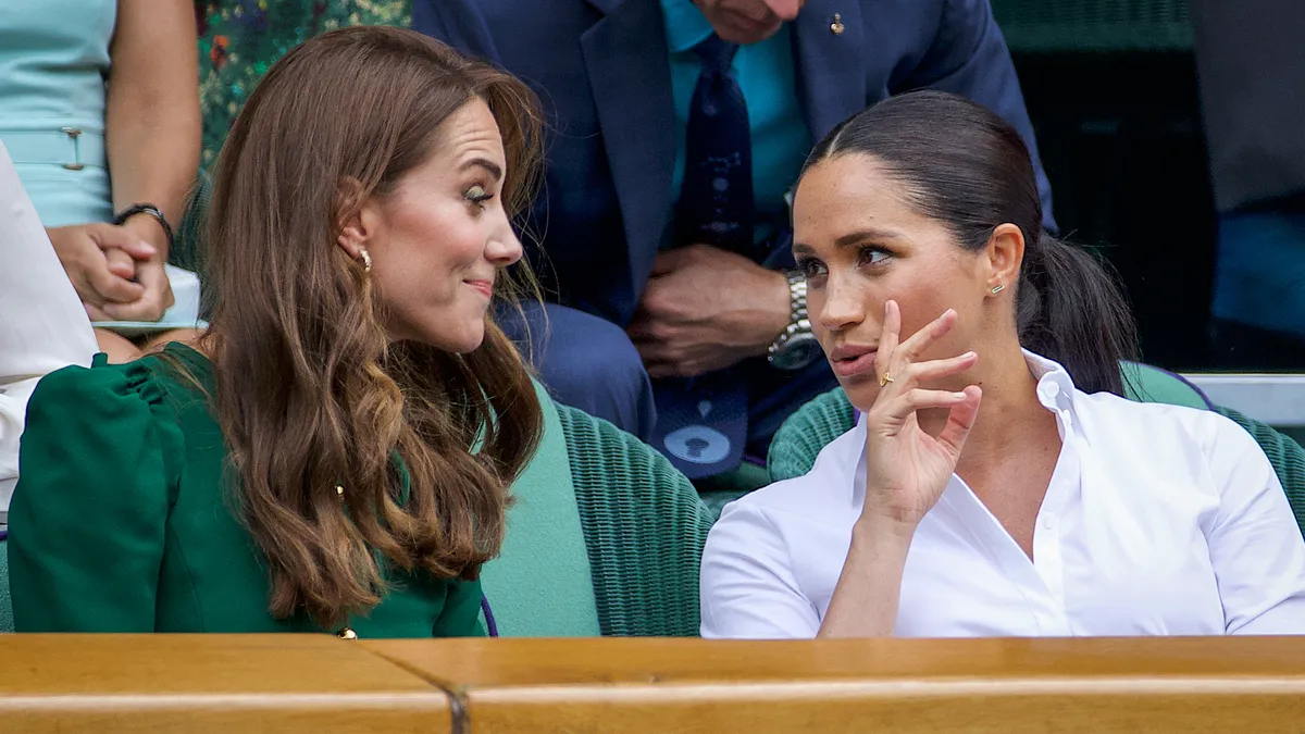 Catherine, Duchess of Cambridge talks with Meghan, Duchess of Sussex in the Royal Box on Centre Court ahead of the Ladies Singles Final between Simona Halep of Romania and Serena Williams of the United States on Centre Court during the Wimbledon Lawn Tennis Championships at the All England Lawn Tennis and Croquet Club at Wimbledon on July 13, 2019 in London, England.