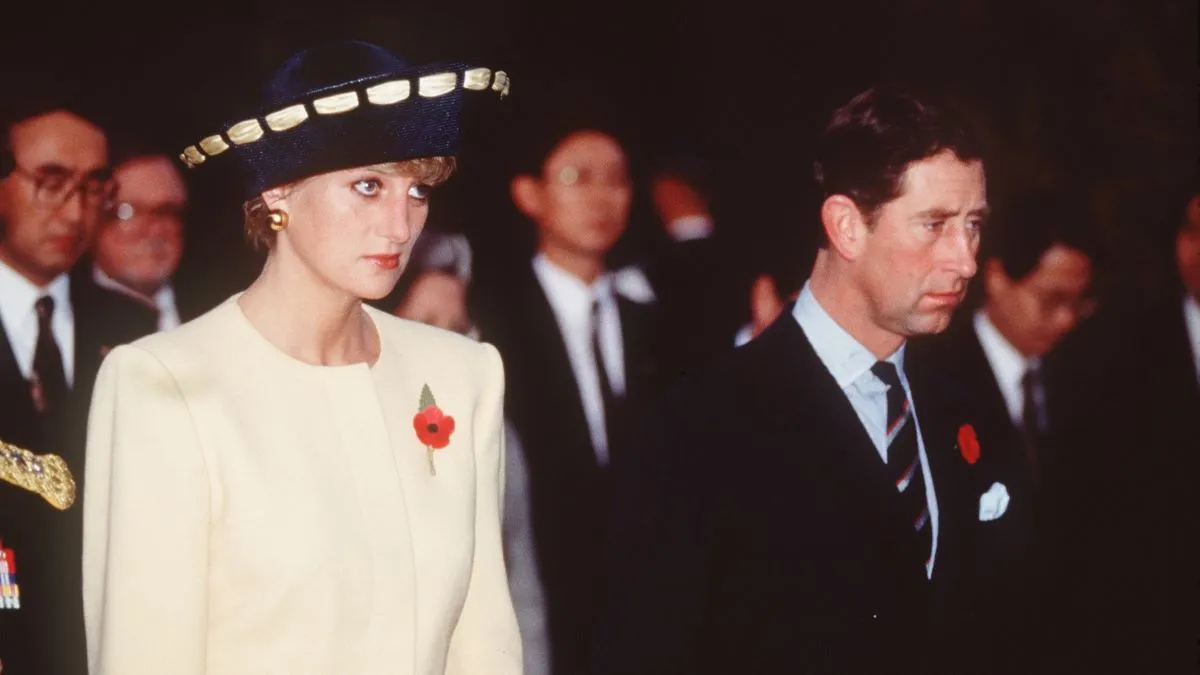 Prince Charles, Prince of Wales and Diana, Princess of Wales, wearing a yellow and navy blue dress and jacket designed by Catherine Walker and a hat by Philip Somerville, visit the National Cemetery on November 2, 1992 in Seoul, South Korea. (Photo by Anwar Hussein/Getty Images)