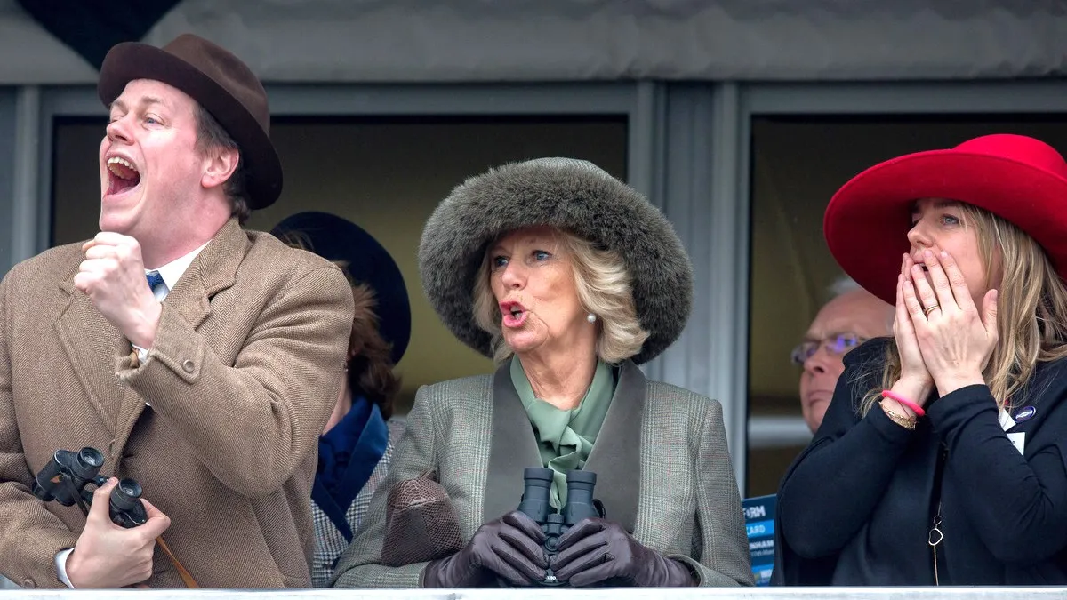 Camilla, Duchess of Cornwall (C) watches a race from the temporary Royal Box with her son Tom Parker Bowles and daughter Laura Lopes on the second day of the Cheltenham Festival on March 11, 2015 in Cheltenham, England. 