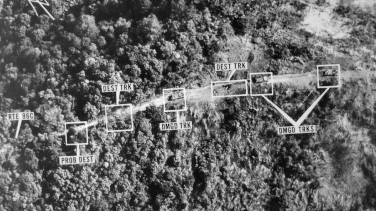 Original Caption) One of the points made by President Richard Nixon in his radio address February 25th was that the purpose of this year's disruption of the Ho Chi Minh Trail is to save lives and ensure the success of the withdrawal program next year. This Air Force photo, made January 31, 1971, shows a trail of damaged and destroyed trucks of the trail's many routes, when they were sighted and attacked. In the picture, DMGD means damages, while Dest means destroyed.