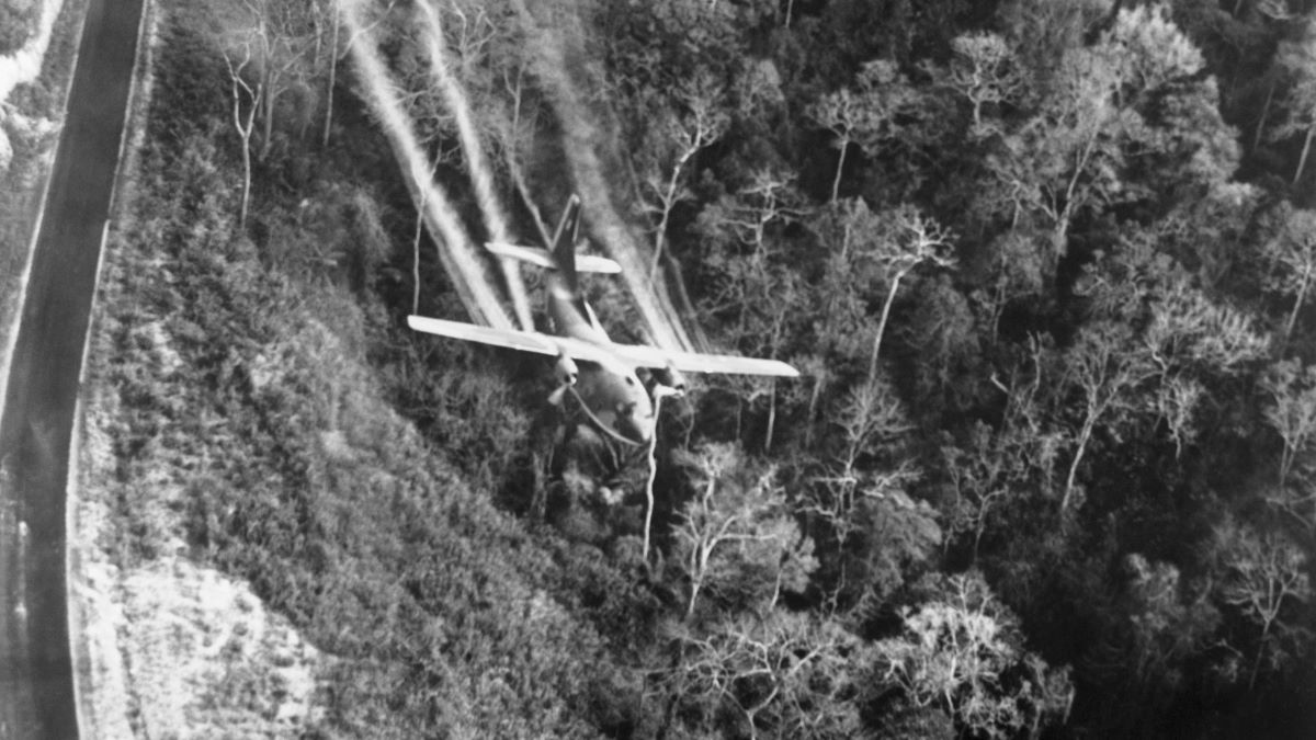 A Fairchild C-123 Provider cargo plane sprays Agent Orange over a forest in North Vietnam.