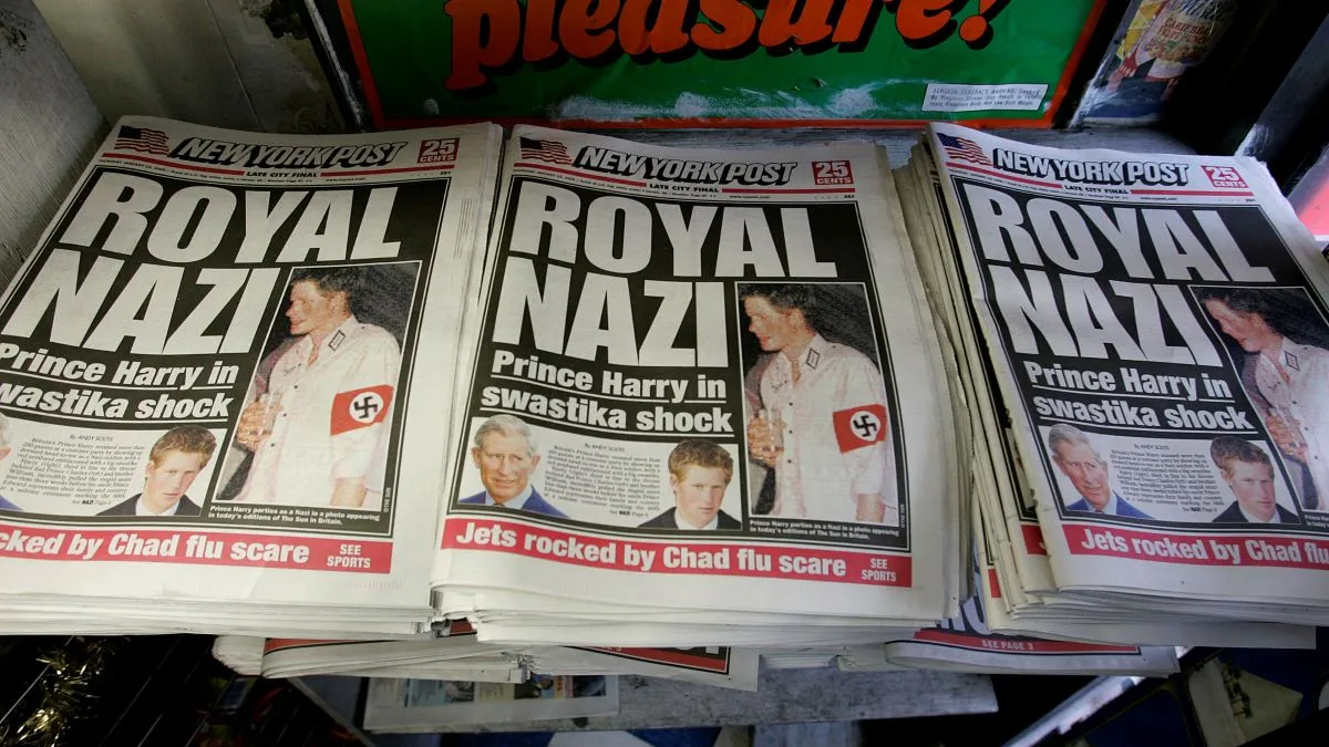 Copies of the New York Post lie on display at a newstand featuring a "Royal Nazi" front page headline January 13, 2005 in New York City. British royal, Prince Harry, reportedly attended a fancy dress party wearing a khaki uniform with an armband emblazoned with a swastika, the emblem of the German WWII Nazi Party. (Photo by Stephen Chernin/Getty Images)